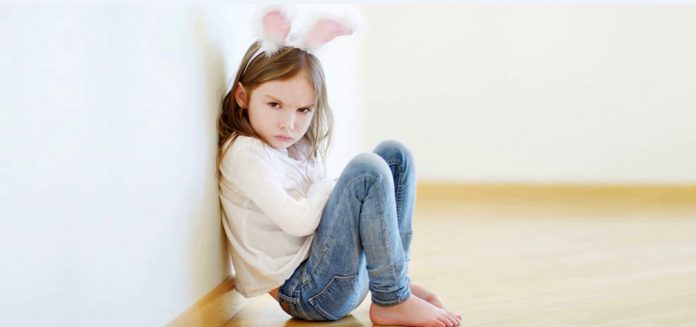 Angry little girl wearing bunny ears